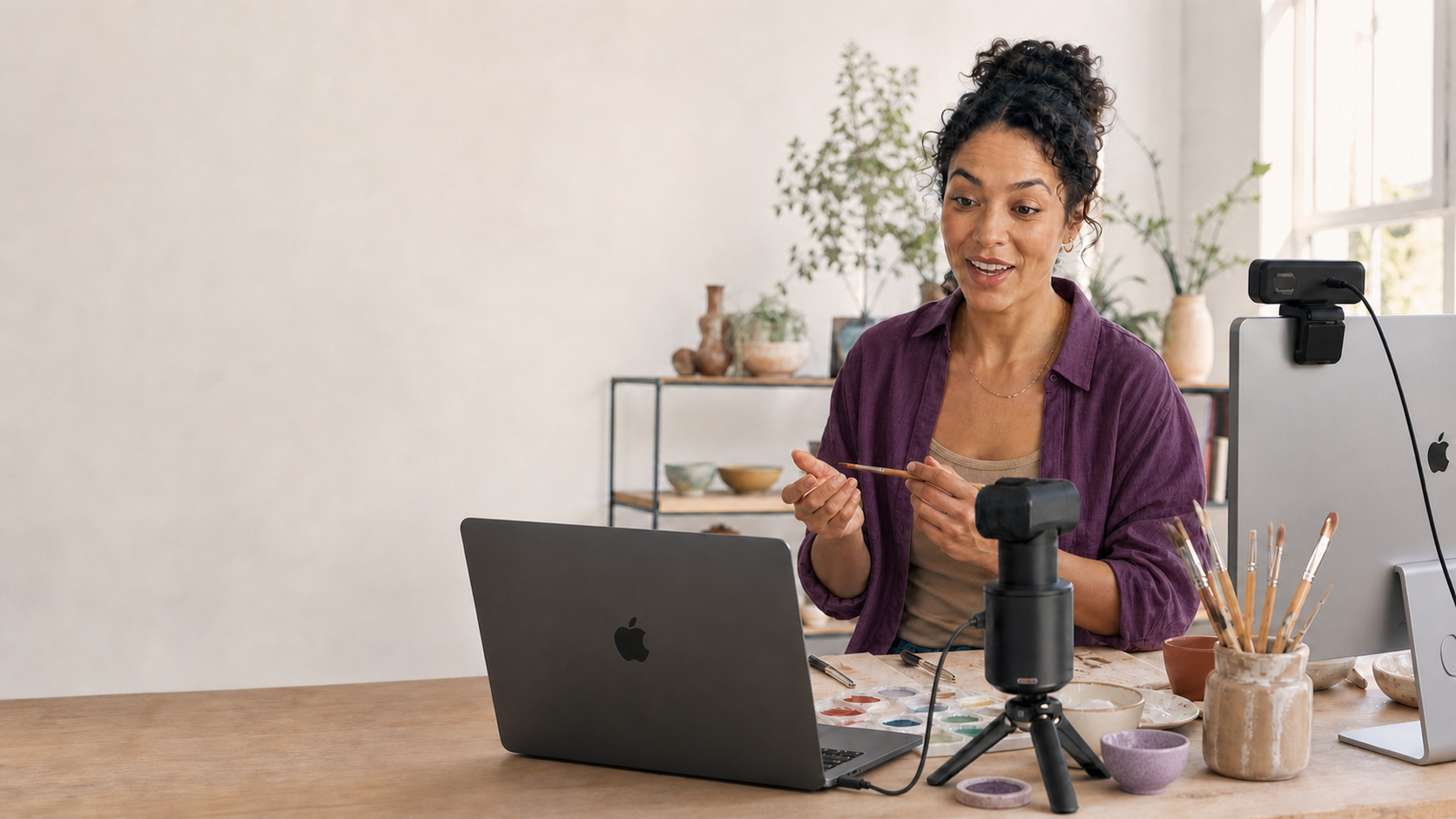 A maker broadcasting from a MacBook with a motorised camera and a USB webcam.